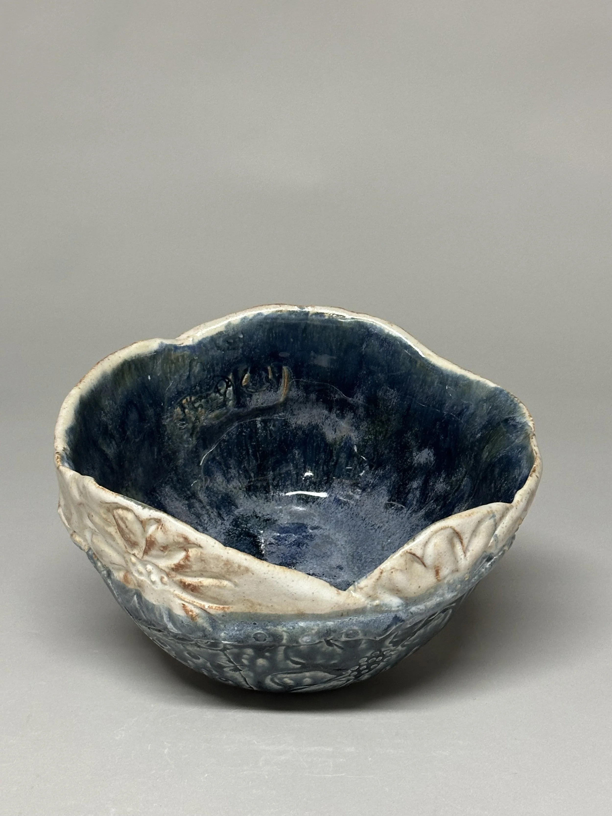 A layered clay daisy bowl glazed in Ash Blue and Shino, bringing soft texture and organic charm to any space. SOLD!