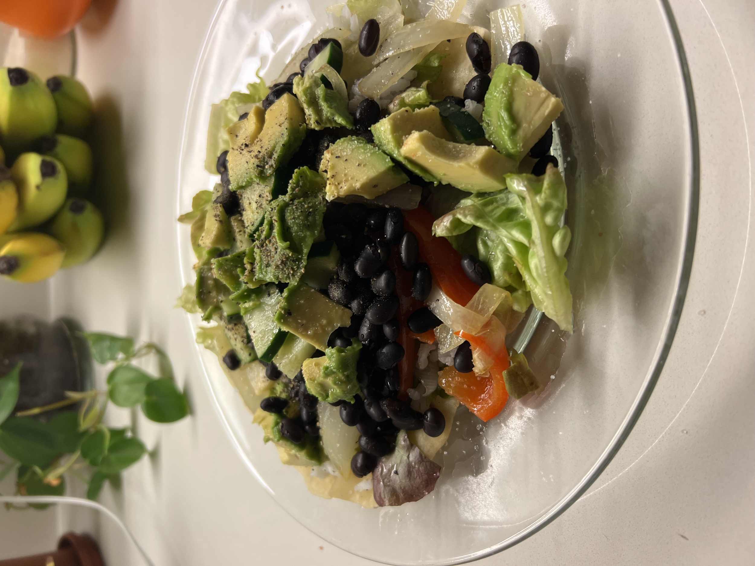 Veggie Tacos made with homemade flour tortillas, black beans, white rice, sautéed peppers and onions, lettuce, tomato, cucumber, avocado, and red onion toppings