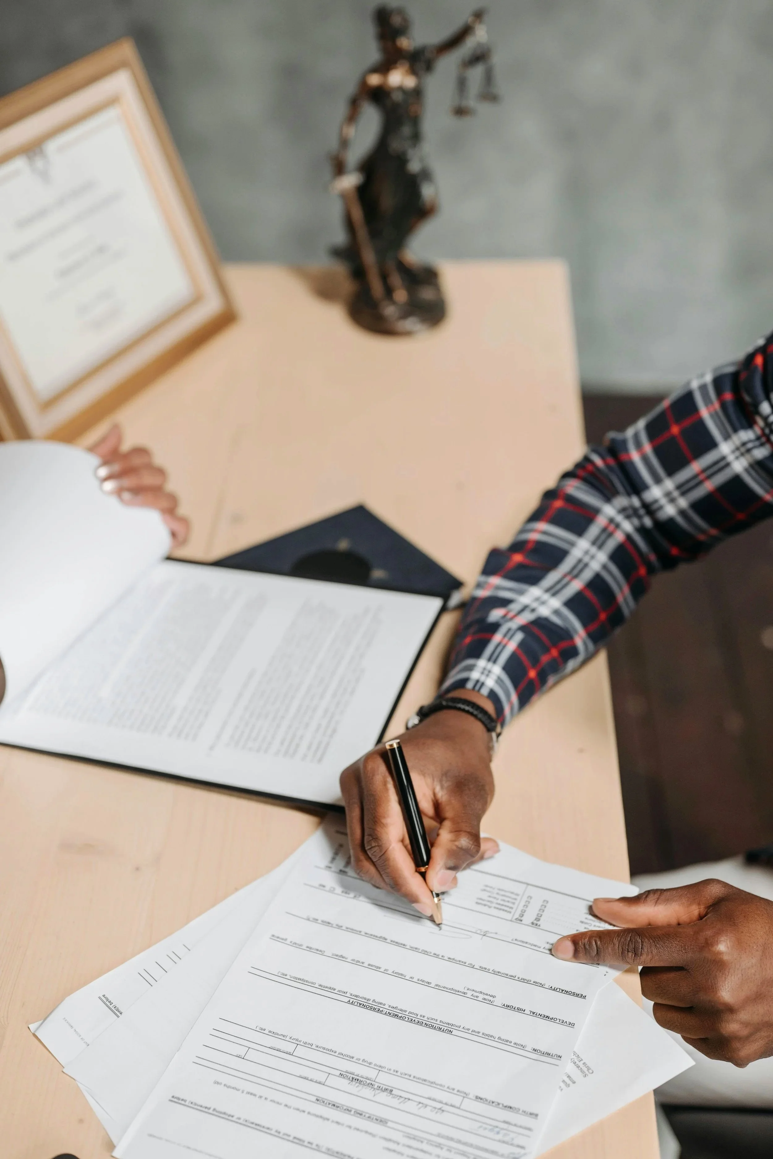 An employee signing some documents.