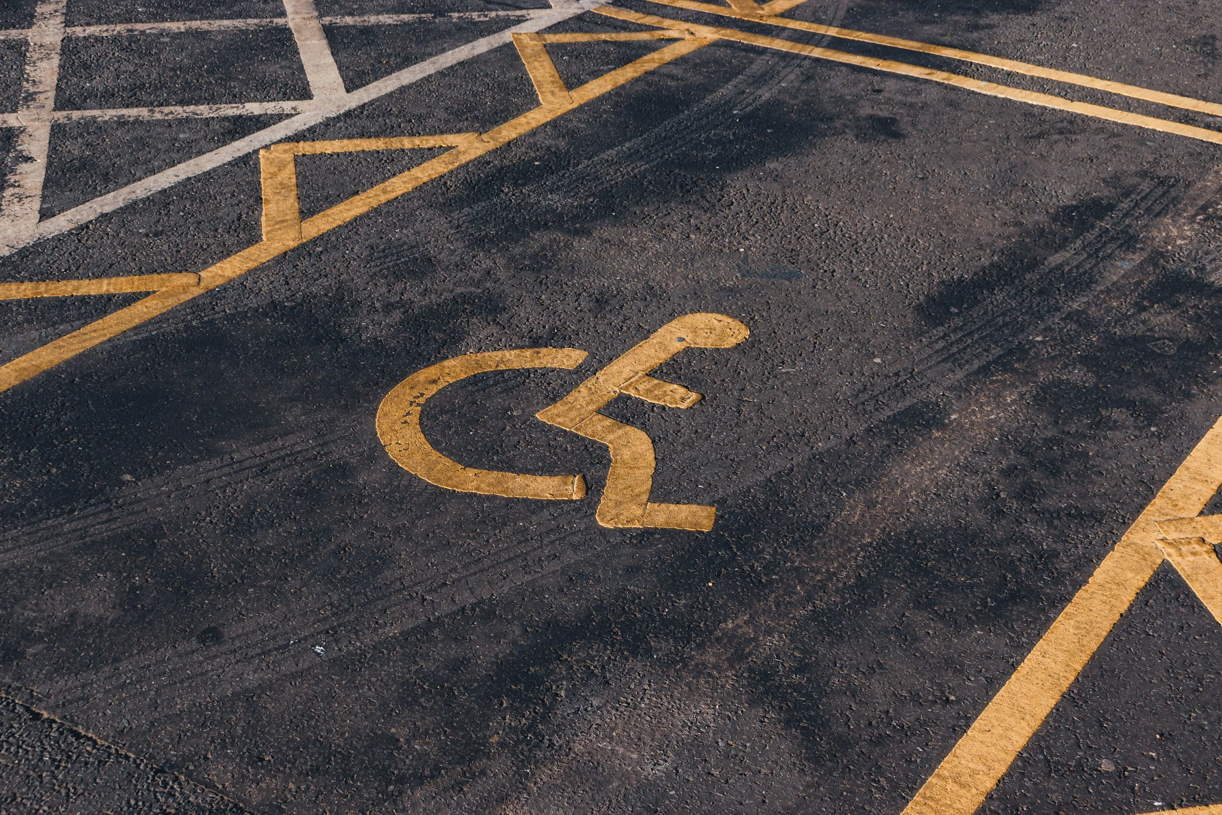 An image of an office parking lot with disabilities symbol