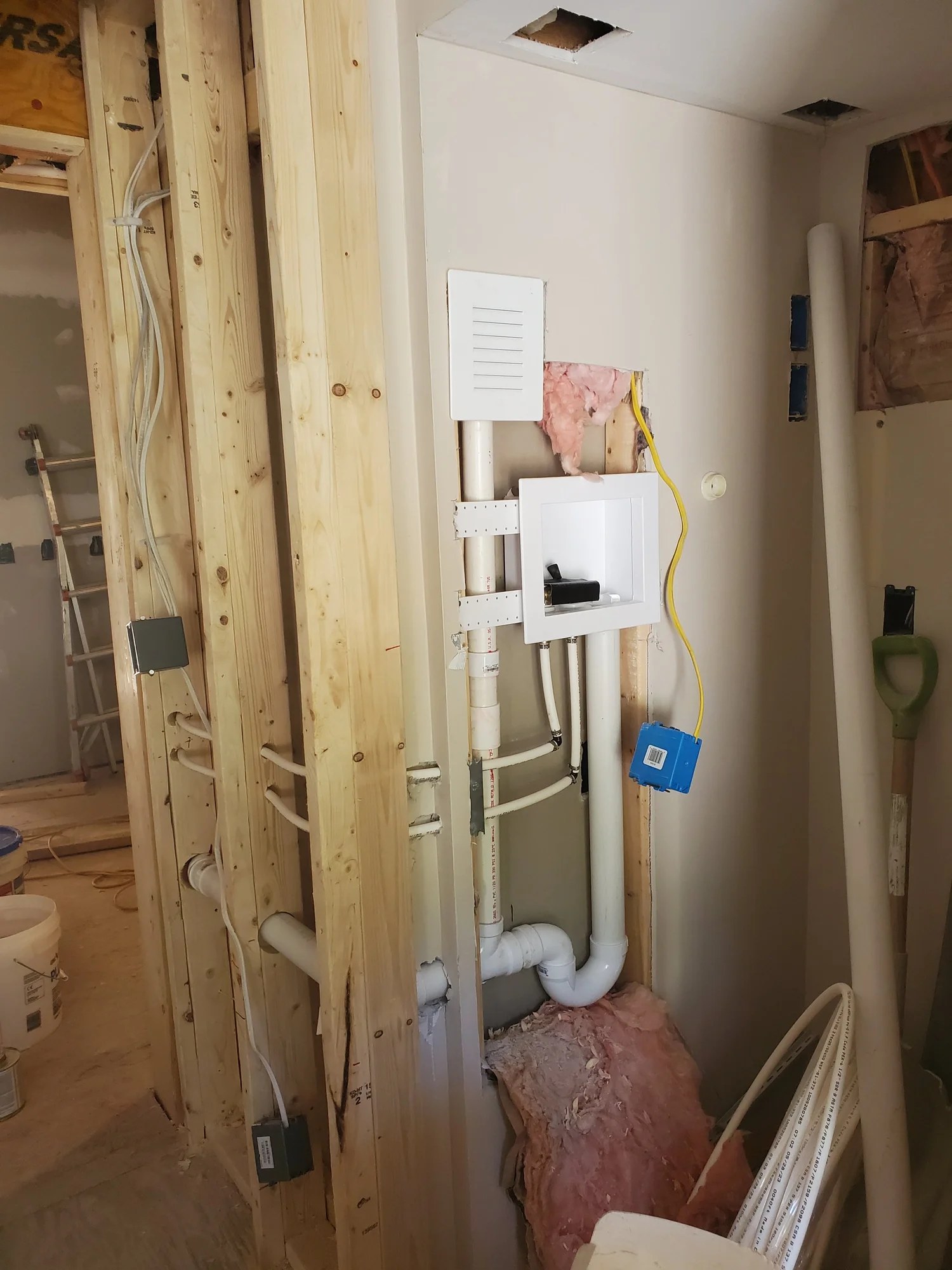 Laundry rough-in with supply lines, drain and washing machine outlet box
