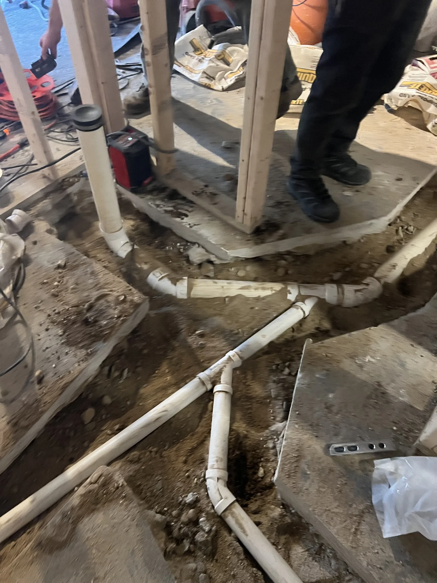 Trenched concrete floor with new underground PVC drain lines