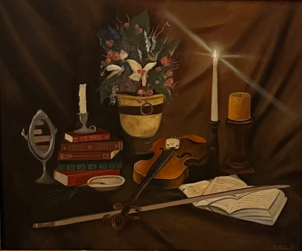 A still life painting featuring a bouquet of flowers in a yellow vase, a stack of red books, a small handheld mirror, a violin with bow, an open book, two lit candles in holders, and a small yellow container, all arranged on a dark surface with a dark background.