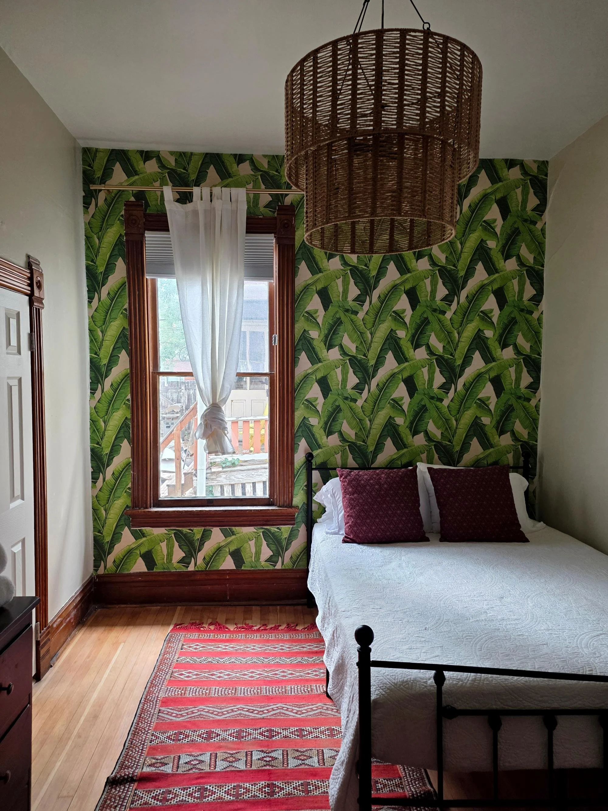 Green botanical wallpaper installation in Denver bedroom accent wall