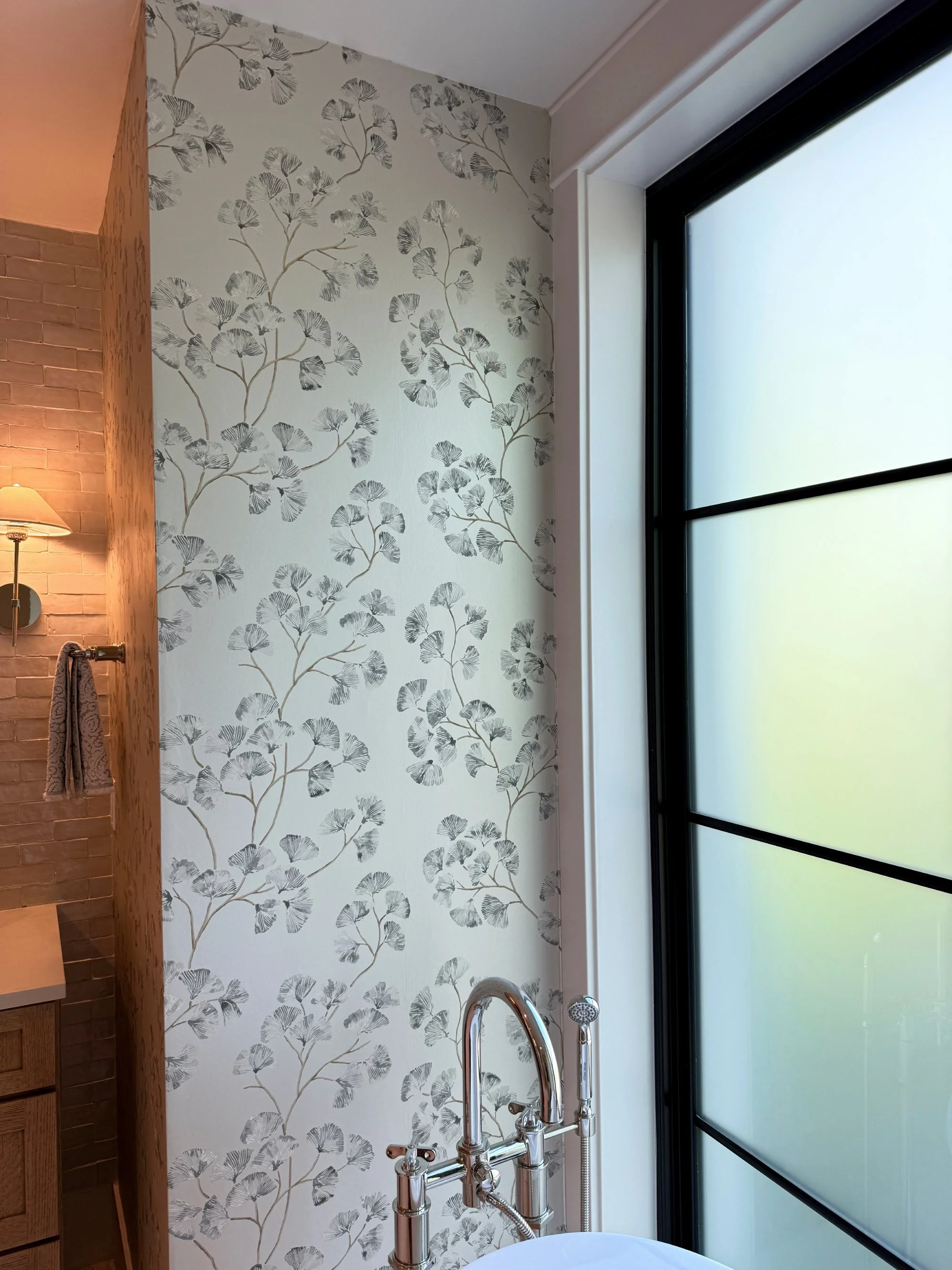 Floral bathroom wallpaper installation next to window in Denver, CO
