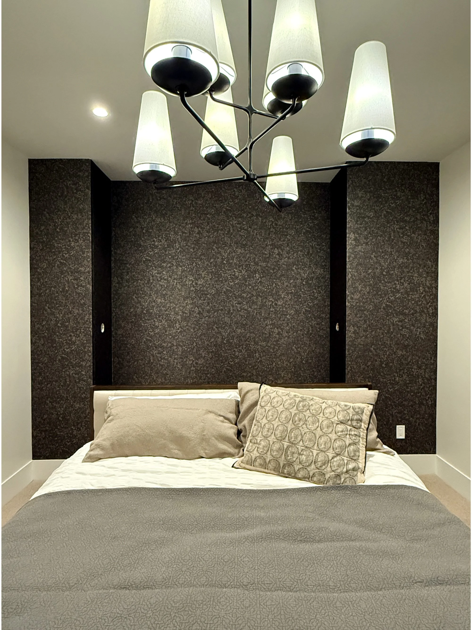 Dark textured wallpaper accent wall installation in Denver bedroom