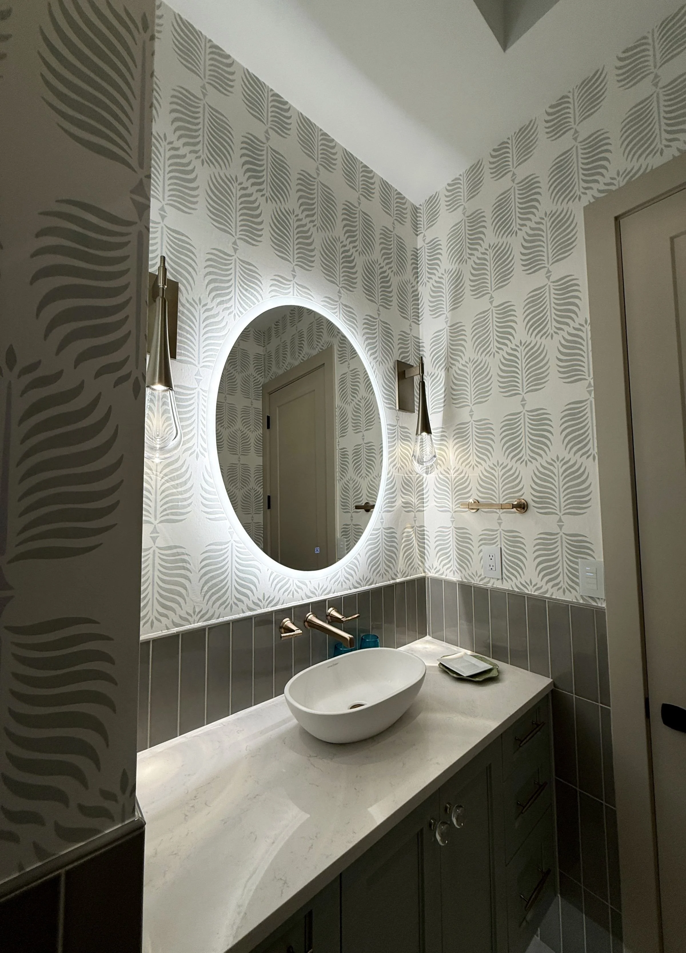 Bathroom wallpaper installation with modern vanity and LED mirror in Denver, CO