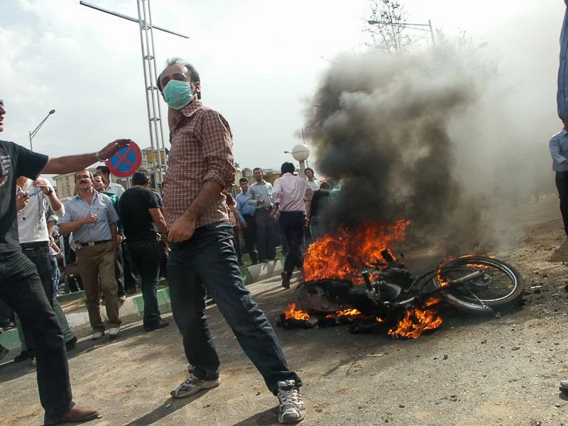 Editorial photograph from the Green Movement protests in Iran during 2009–2010, documenting public demonstrations, civic resistance, and everyday life under heightened security conditions. Part of a long-form documentary project by photographer Farha