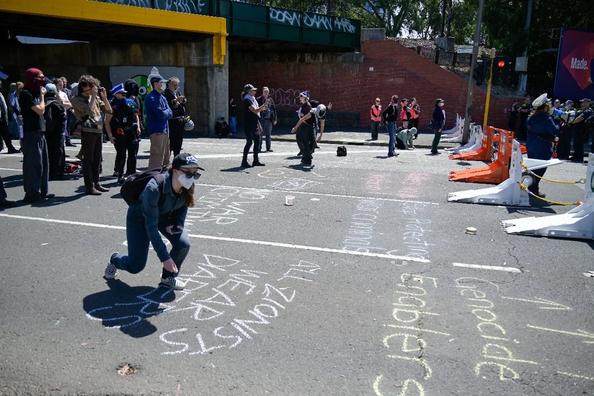 Documentary photograph taken during the Israeli President’s visit to Melbourne on 12 February, capturing protests in Southbank and the CBD, police security measures, and street-level tensions. | photo by Farhad Rajabali