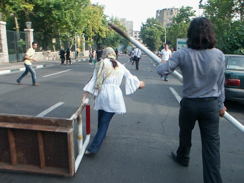 Editorial photograph from the Green Movement protests in Iran during 2009–2010, documenting public demonstrations, civic resistance, and everyday life under heightened security conditions. Part of a long-form documentary project by photographer Farha