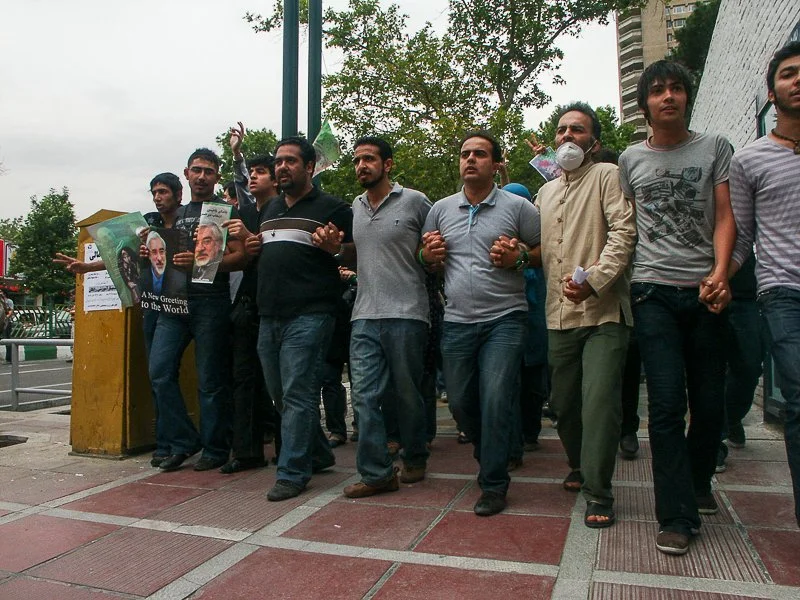 Editorial photograph from the Green Movement protests in Iran during 2009–2010, documenting public demonstrations, civic resistance, and everyday life under heightened security conditions. Part of a long-form documentary project by photographer Farha