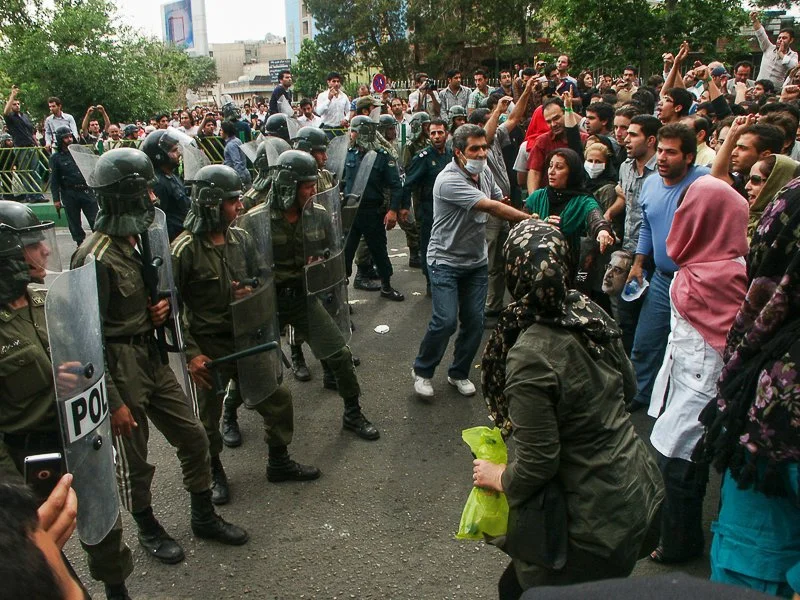Editorial photograph from the Green Movement protests in Iran during 2009–2010, documenting public demonstrations, civic resistance, and everyday life under heightened security conditions. Part of a long-form documentary project by photographer Farha