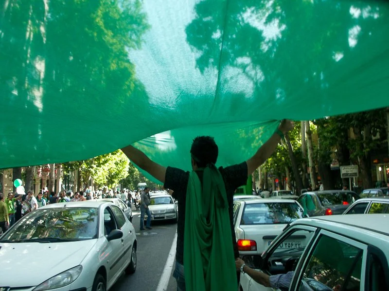 Editorial photograph from the Green Movement protests in Iran during 2009–2010, documenting public demonstrations, civic resistance, and everyday life under heightened security conditions. Part of a long-form documentary project by photographer Farha