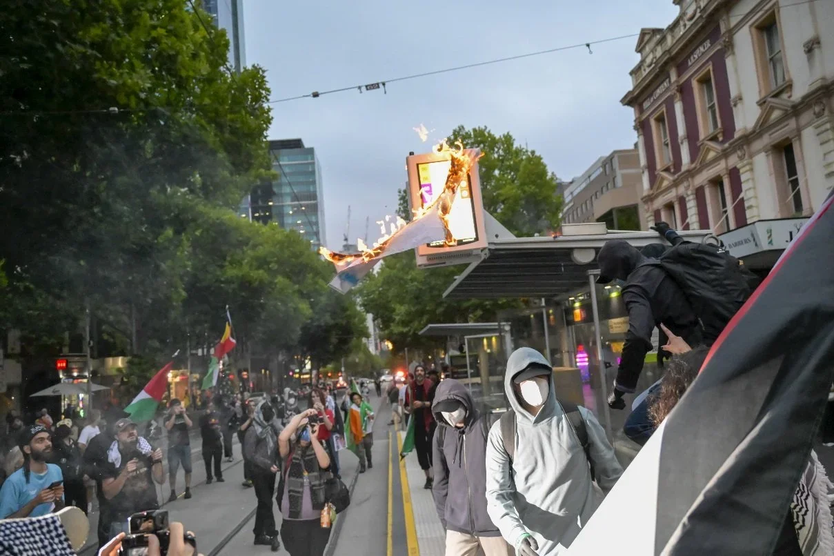 Documentary photograph from a pro-Palestine march through Melbourne’s CBD, capturing public protest, political expression, and street-level moments.
Photo by Farhad Rajabali | Artssie