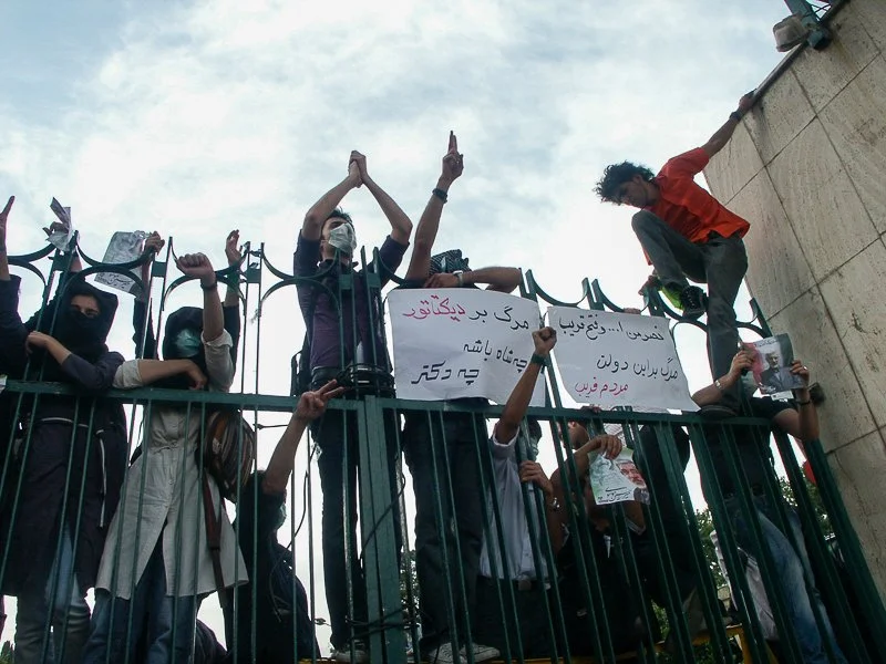 Editorial photograph from the Green Movement protests in Iran during 2009–2010, documenting public demonstrations, civic resistance, and everyday life under heightened security conditions. Part of a long-form documentary project by photographer Farha