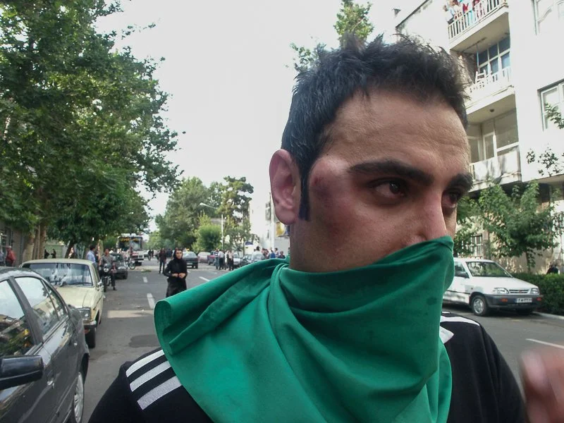 Editorial photograph from the Green Movement protests in Iran during 2009–2010, documenting public demonstrations, civic resistance, and everyday life under heightened security conditions. Part of a long-form documentary project by photographer Farha