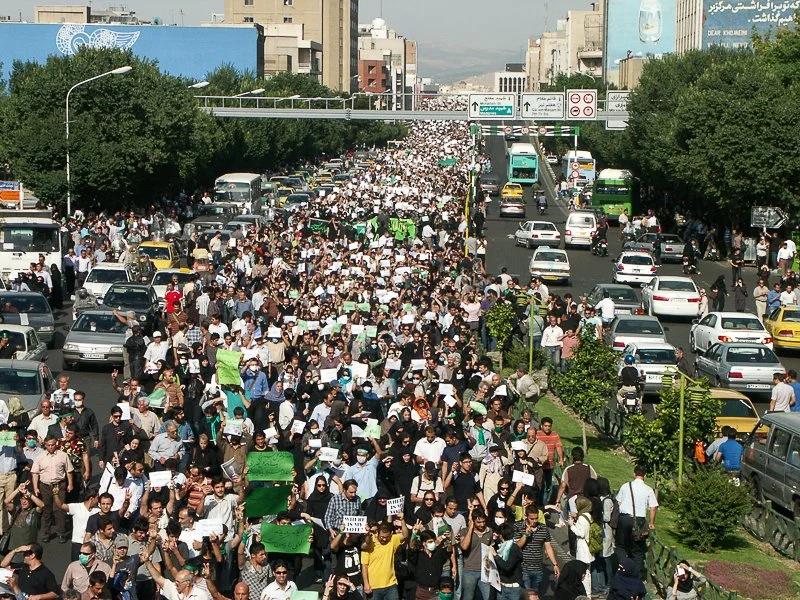 Editorial photograph from the Green Movement protests in Iran during 2009–2010, documenting public demonstrations, civic resistance, and everyday life under heightened security conditions. Part of a long-form documentary project by photographer Farha