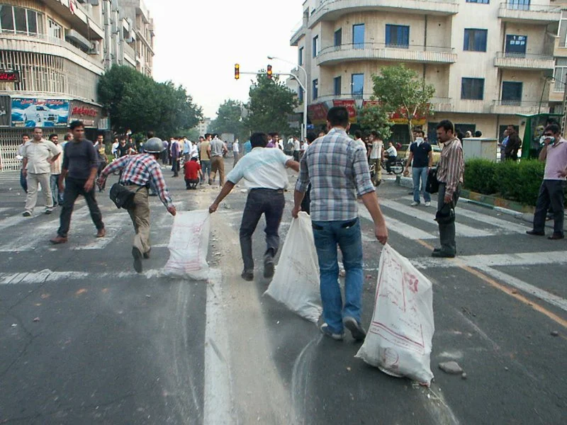 Editorial photograph from the Green Movement protests in Iran during 2009–2010, documenting public demonstrations, civic resistance, and everyday life under heightened security conditions. Part of a long-form documentary project by photographer Farha