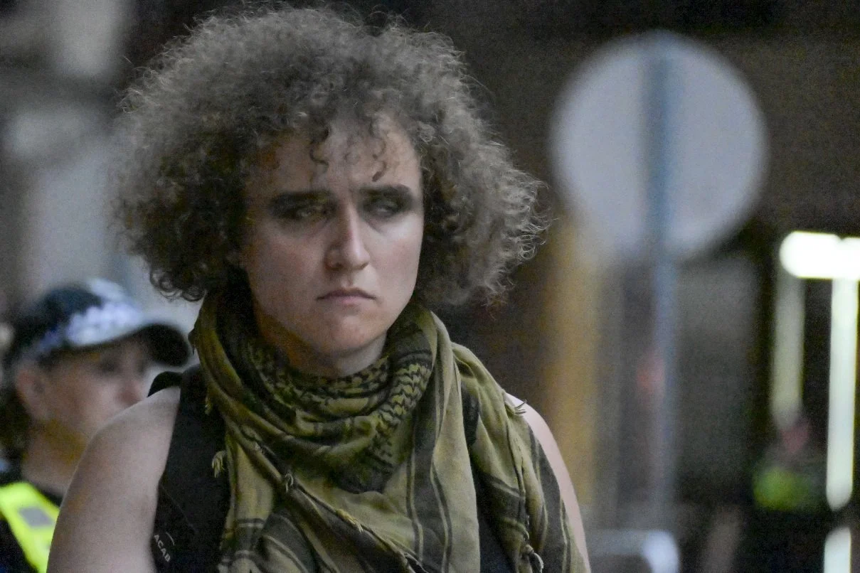 This documentary photograph was taken during a pro-Palestine march through Melbourne’s CBD, showing public protest, political symbolism, and everyday human moments within an urban demonstration. Photo by Farhad Rajabali