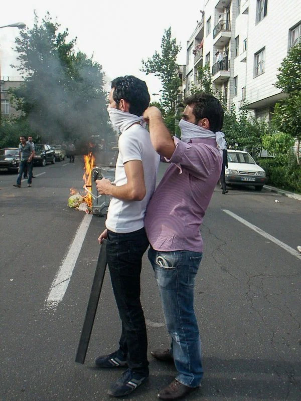 Editorial photograph from the Green Movement protests in Iran during 2009–2010, documenting public demonstrations, civic resistance, and everyday life under heightened security conditions. Part of a long-form documentary project by photographer Farha