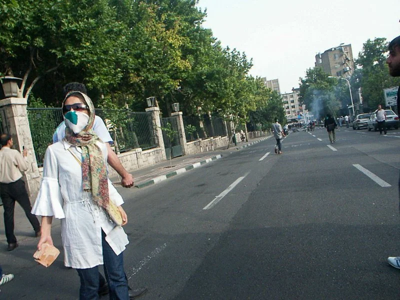 Editorial photograph from the Green Movement protests in Iran during 2009–2010, documenting public demonstrations, civic resistance, and everyday life under heightened security conditions. Part of a long-form documentary project by photographer Farha