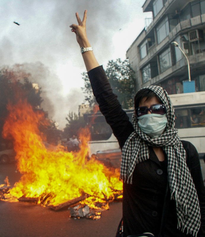 Editorial photograph from the Green Movement protests in Iran during 2009–2010, documenting public demonstrations, civic resistance, and everyday life under heightened security conditions. Part of a long-form documentary project by photographer Farha