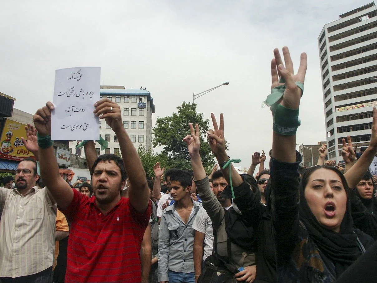 This image is part of the Green Movement documentary series, recorded during the 2009 protests in Tehran, Iran. The project documents everyday scenes and public demonstrations, reflecting resilience, collective presence, and civilian life during a si