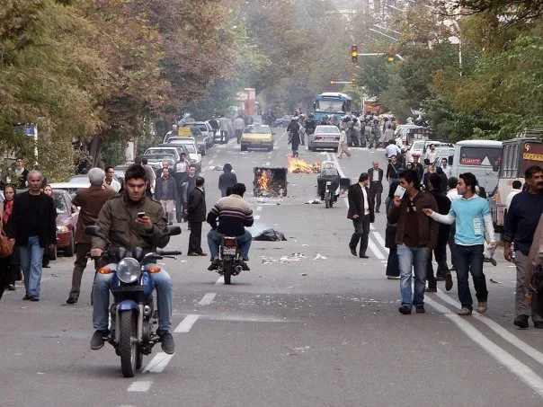 This image is part of the Green Movement documentary series, recorded during the 2009 protests in Tehran, Iran. The project documents everyday scenes and public demonstrations, reflecting resilience, collective presence, and civilian life during a si