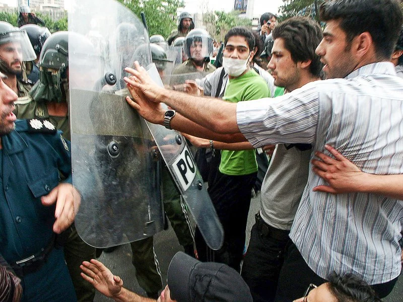 Editorial photograph from the Green Movement protests in Iran during 2009–2010, documenting public demonstrations, civic resistance, and everyday life under heightened security conditions. Part of a long-form documentary project by photographer Farha