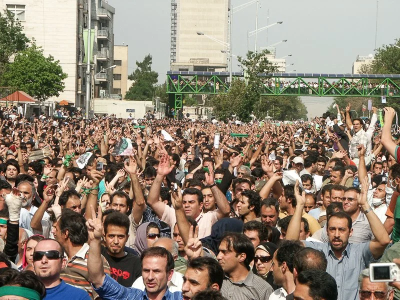 Editorial photograph from the Green Movement protests in Iran during 2009–2010, documenting public demonstrations, civic resistance, and everyday life under heightened security conditions. Part of a long-form documentary project by photographer Farha