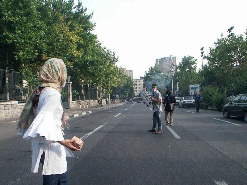Editorial photograph from the Green Movement protests in Iran during 2009–2010, documenting public demonstrations, civic resistance, and everyday life under heightened security conditions. Part of a long-form documentary project by photographer Farha