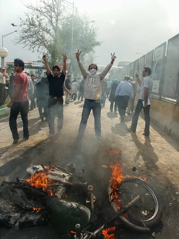 Editorial photograph from the Green Movement protests in Iran during 2009–2010, documenting public demonstrations, civic resistance, and everyday life under heightened security conditions. Part of a long-form documentary project by photographer Farha