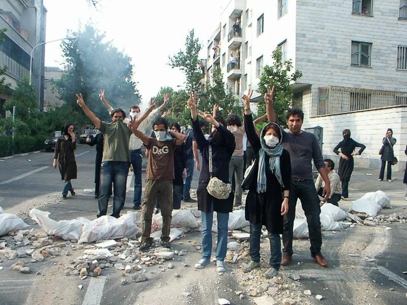 Editorial photograph from the Green Movement protests in Iran during 2009–2010, documenting public demonstrations, civic resistance, and everyday life under heightened security conditions. Part of a long-form documentary project by photographer Farha