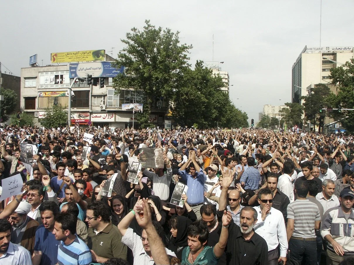 This image is part of the Green Movement documentary series, recorded during the 2009 protests in Tehran, Iran. The project documents everyday scenes and public demonstrations, reflecting resilience, collective presence, and civilian life during a si
