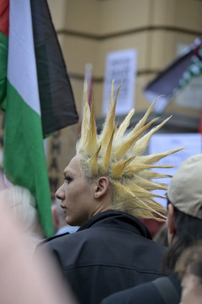 This documentary photograph was taken during a pro-Palestine march through Melbourne’s CBD, showing public protest, political symbolism, and everyday human moments within an urban demonstration. Photo by Farhad Rajabali