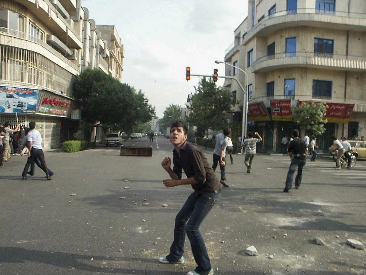 This image is part of the Green Movement documentary series, recorded during the 2009 protests in Tehran, Iran. The project documents everyday scenes and public demonstrations, reflecting resilience, collective presence, and civilian life during a si