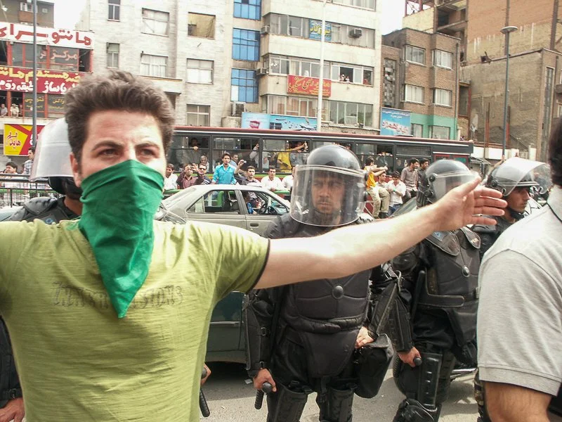 Editorial photograph from the Green Movement protests in Iran during 2009–2010, documenting public demonstrations, civic resistance, and everyday life under heightened security conditions. Part of a long-form documentary project by photographer Farha