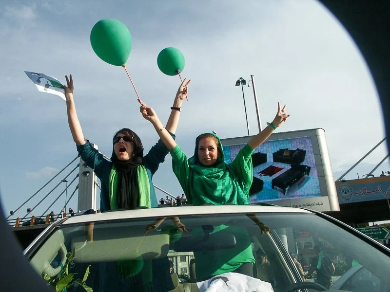 Editorial photograph from the Green Movement protests in Iran during 2009–2010, documenting public demonstrations, civic resistance, and everyday life under heightened security conditions. Part of a long-form documentary project by photographer Farha