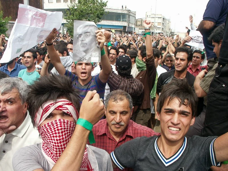 Editorial photograph from the Green Movement protests in Iran during 2009–2010, documenting public demonstrations, civic resistance, and everyday life under heightened security conditions. Part of a long-form documentary project by photographer Farha