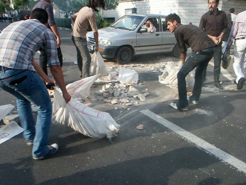 Editorial photograph from the Green Movement protests in Iran during 2009–2010, documenting public demonstrations, civic resistance, and everyday life under heightened security conditions. Part of a long-form documentary project by photographer Farha