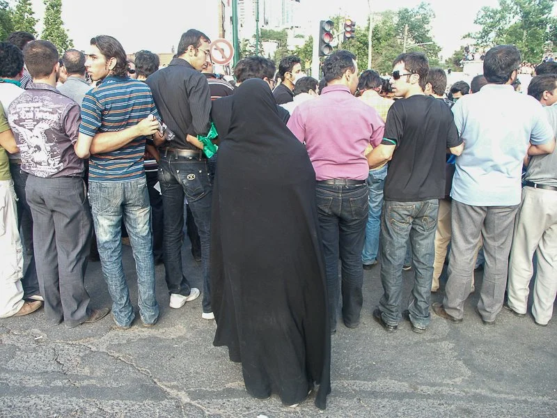 Editorial photograph from the Green Movement protests in Iran during 2009–2010, documenting public demonstrations, civic resistance, and everyday life under heightened security conditions. Part of a long-form documentary project by photographer Farha