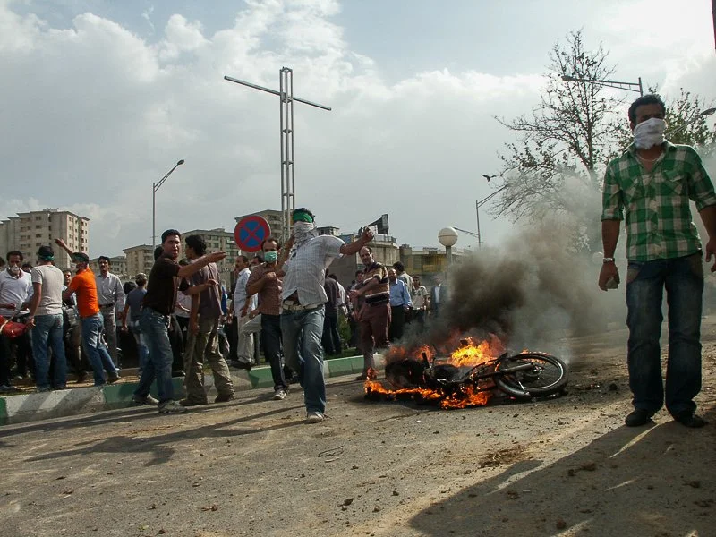 Editorial photograph from the Green Movement protests in Iran during 2009–2010, documenting public demonstrations, civic resistance, and everyday life under heightened security conditions. Part of a long-form documentary project by photographer Farha