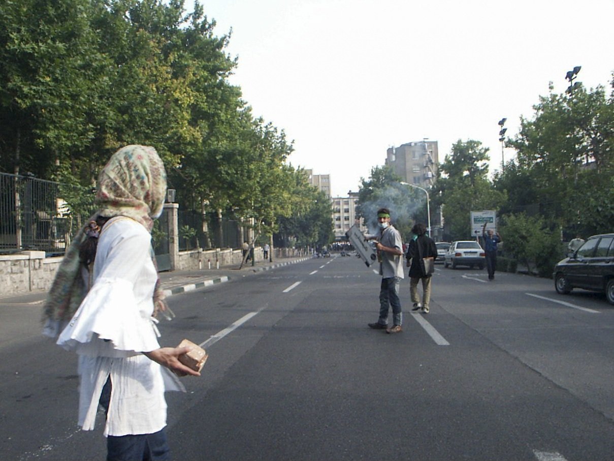 This image is part of the Green Movement documentary series, recorded during the 2009 protests in Tehran, Iran. The project documents everyday scenes and public demonstrations, reflecting resilience, collective presence, and civilian life during a si