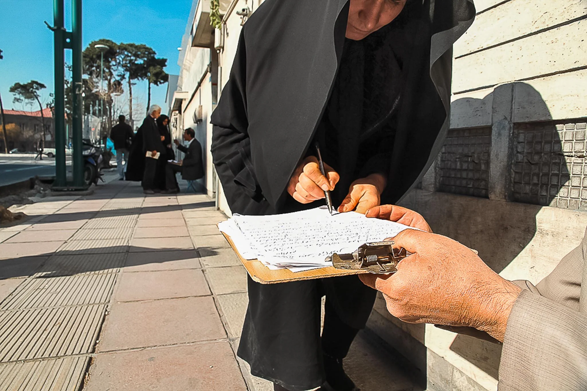 A documentary photo essay about petition writers and citizens seeking government assistance outside the Presidential Office in Tehran, Iran, photographed in December 2011. | photo by Farhad Rajabali