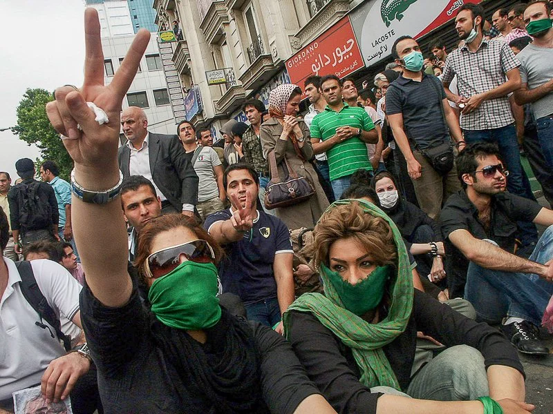 Editorial photograph from the Green Movement protests in Iran during 2009–2010, documenting public demonstrations, civic resistance, and everyday life under heightened security conditions. Part of a long-form documentary project by photographer Farha