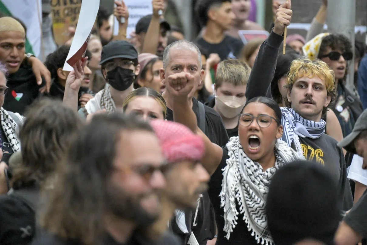 Documentary photograph from a pro-Palestine march through Melbourne’s CBD, capturing public protest, political expression, and street-level moments.
Photo by Farhad Rajabali | Artssie