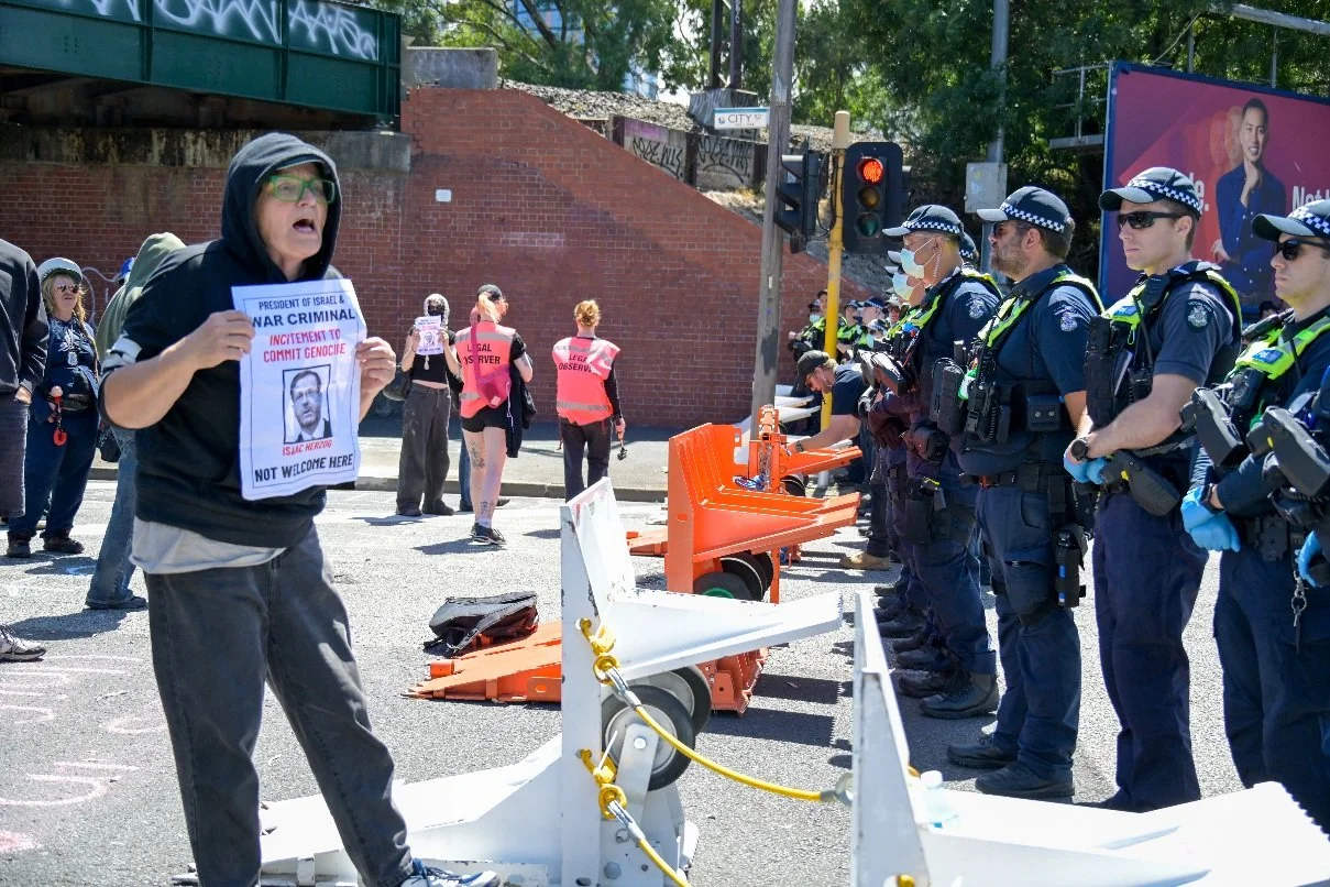 Documentary photograph taken during the Israeli President’s visit to Melbourne on 12 February, capturing protests in Southbank and the CBD, police security measures, and street-level tensions. | photo by Farhad Rajabali