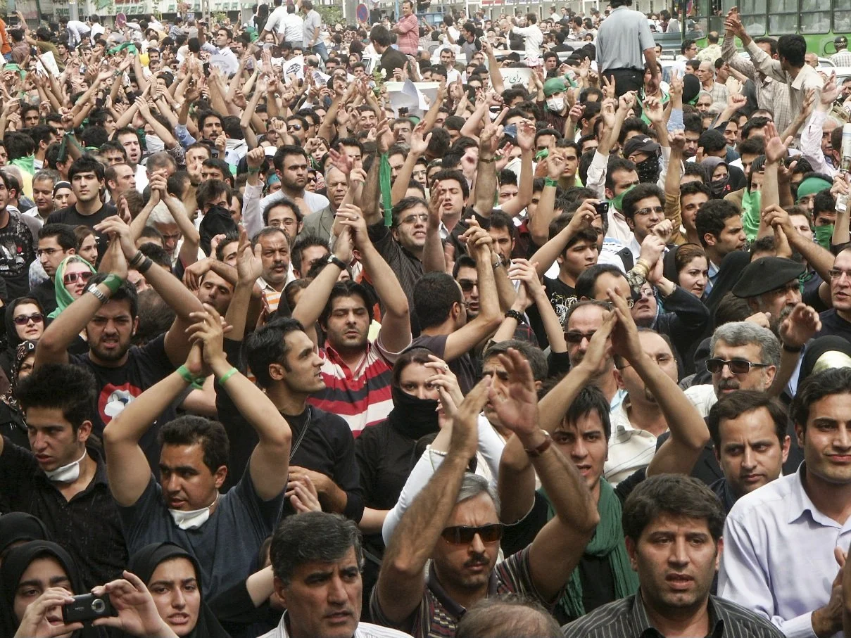 This image is part of the Green Movement documentary series, recorded during the 2009 protests in Tehran, Iran. The project documents everyday scenes and public demonstrations, reflecting resilience, collective presence, and civilian life during a si