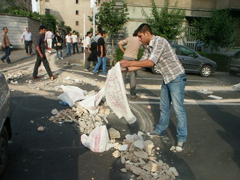 Editorial photograph from the Green Movement protests in Iran during 2009–2010, documenting public demonstrations, civic resistance, and everyday life under heightened security conditions. Part of a long-form documentary project by photographer Farha