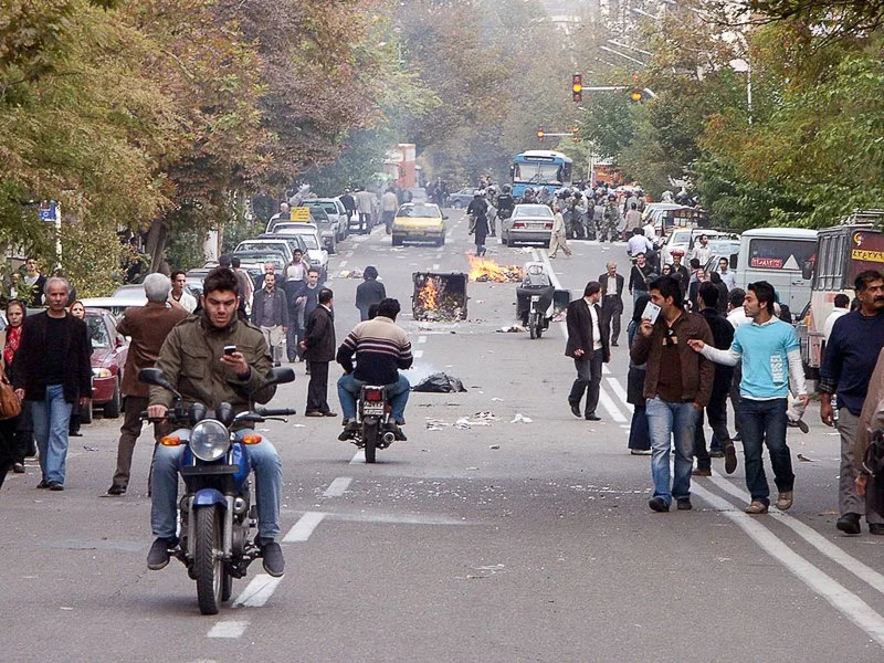 Editorial photograph from the Green Movement protests in Iran during 2009–2010, documenting public demonstrations, civic resistance, and everyday life under heightened security conditions. Part of a long-form documentary project by photographer Farha